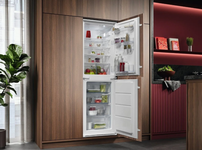 Integrated AEG fridge freezer built into a walnut tall unit run