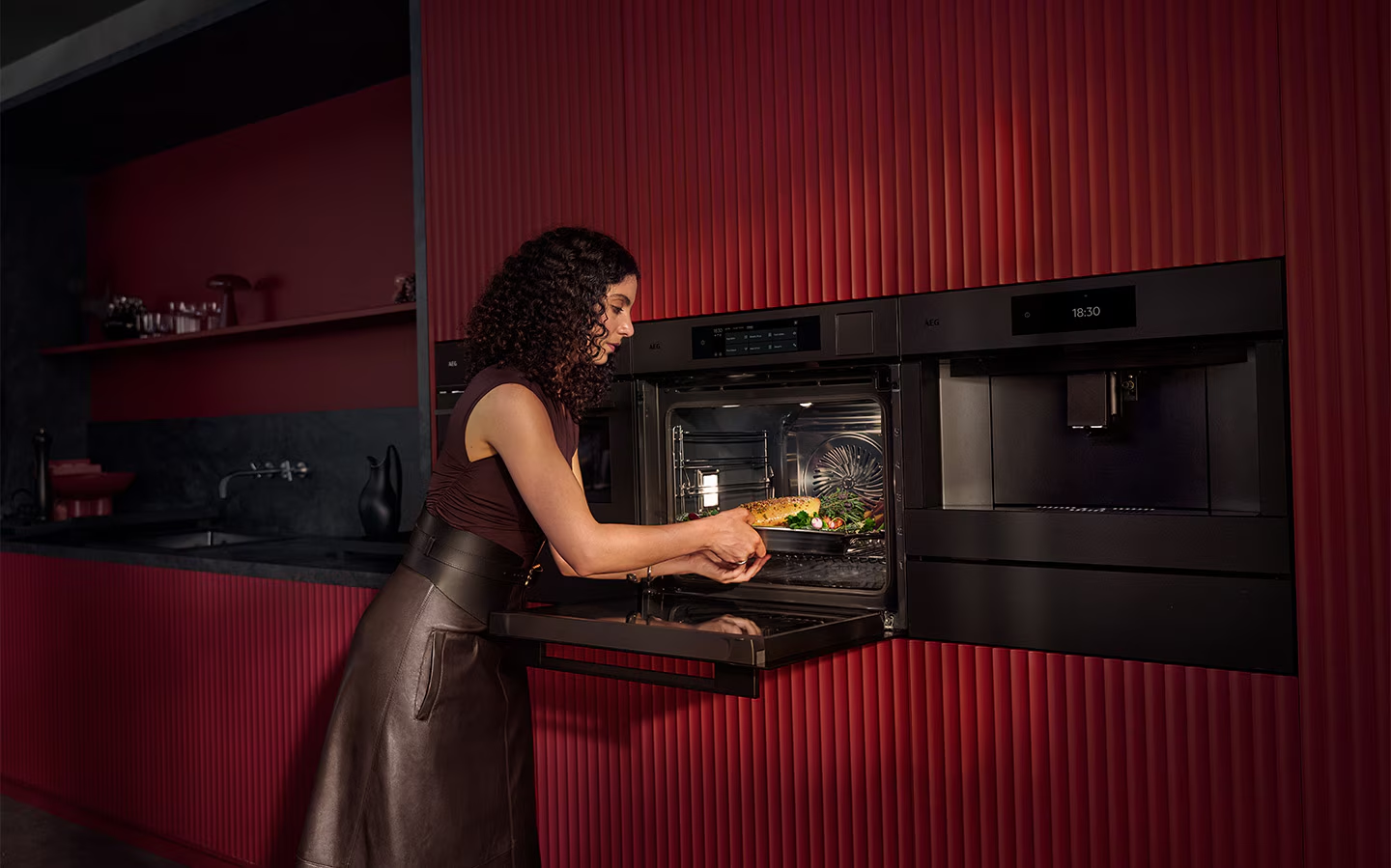Built-in AEG steam oven open in a deep red ribbed tall housing