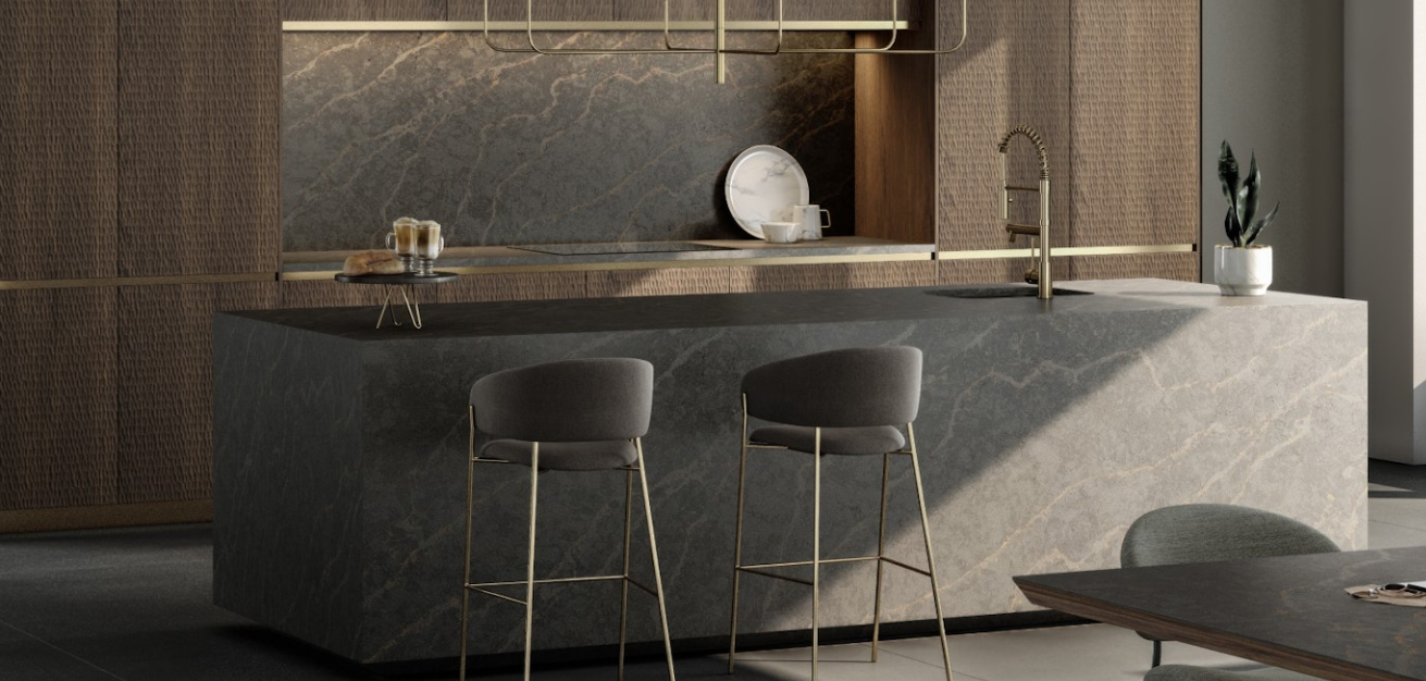 Silestone island in dark veined stone with a matching splashback above fluted oak cabinetry